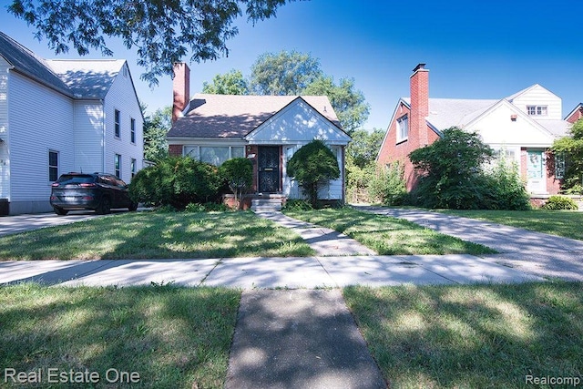 8035 Pinehurst St, Detroit, MI 48204 - english style home featuring a front yard and a chimney