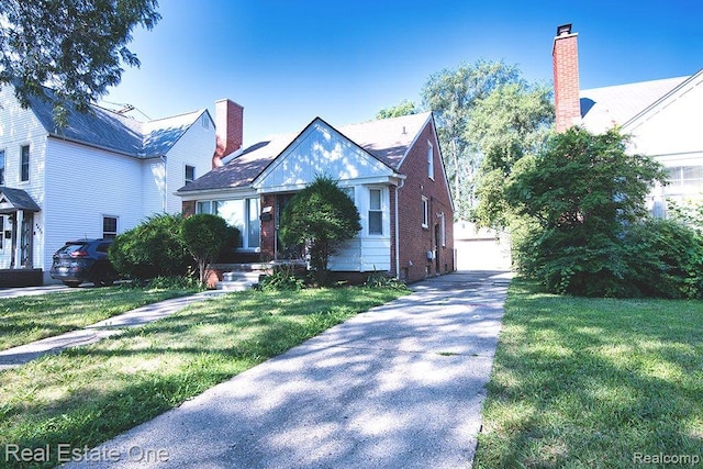 8035 Pinehurst St, Detroit, MI 48204 - view of front of house with a front lawn, a detached garage, a chimney, and brick siding