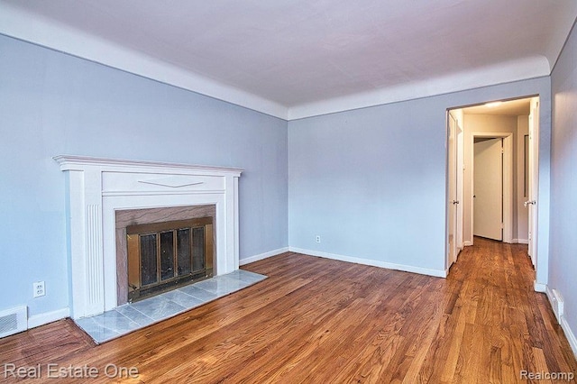 8035 Pinehurst St, Detroit, MI 48204 - unfurnished living room featuring a premium fireplace and wood finished floors