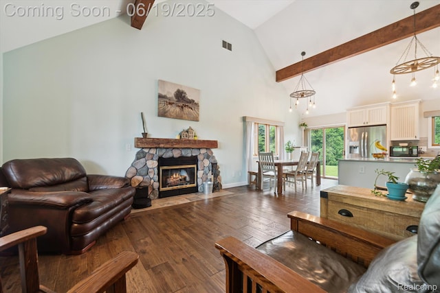 9808 Crofoot Rd, Fowlerville, MI 48836 - living area featuring high vaulted ceiling, a stone fireplace, dark wood-type flooring, beam ceiling, and a chandelier