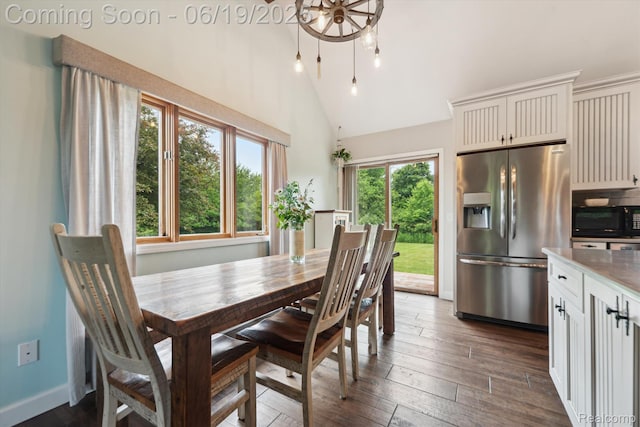 9808 Crofoot Rd, Fowlerville, MI 48836 - dining room with dark wood finished floors, high vaulted ceiling, and a chandelier