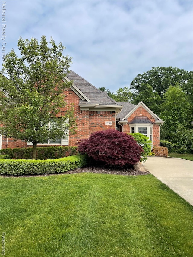 2750 Castlemartin Ct, Oakland, MI 48306 - view of property exterior with brick siding and a yard