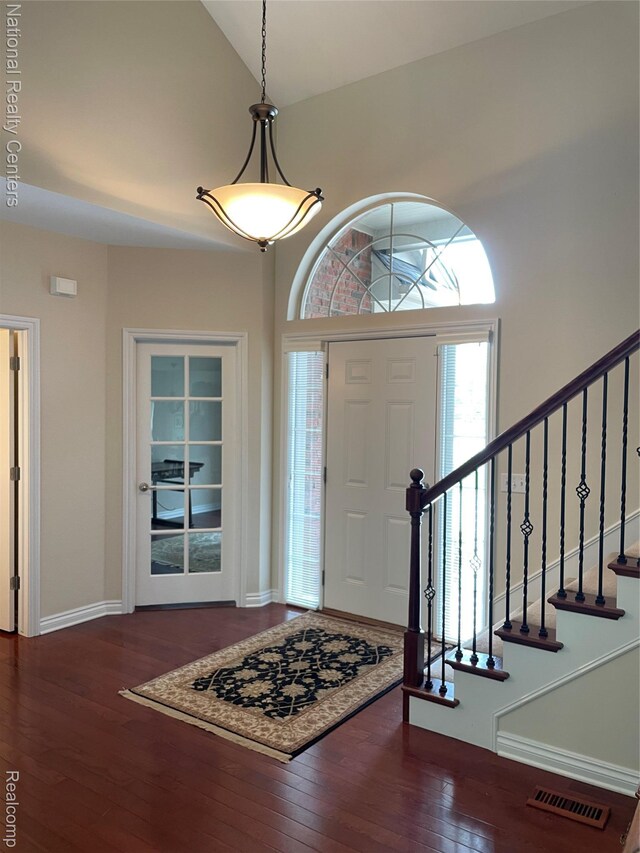 2750 Castlemartin Ct, Oakland, MI 48306 - entrance foyer with high vaulted ceiling, dark wood finished floors, baseboards, and stairway