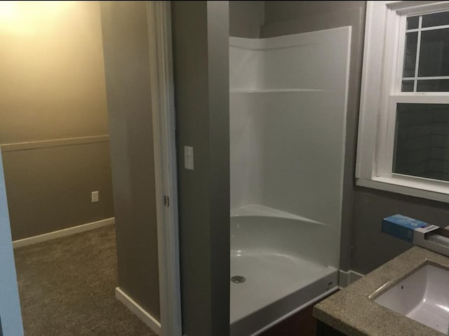 1116 Covell Ave NW, Grand Rapids, MI 49504 - bathroom with vanity, a shower, and baseboards