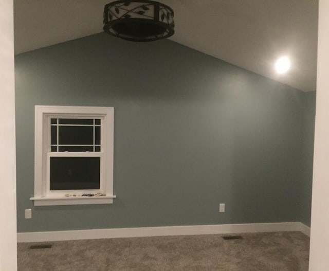 1116 Covell Ave NW, Grand Rapids, MI 49504 - unfurnished room with vaulted ceiling, carpet flooring, and baseboards