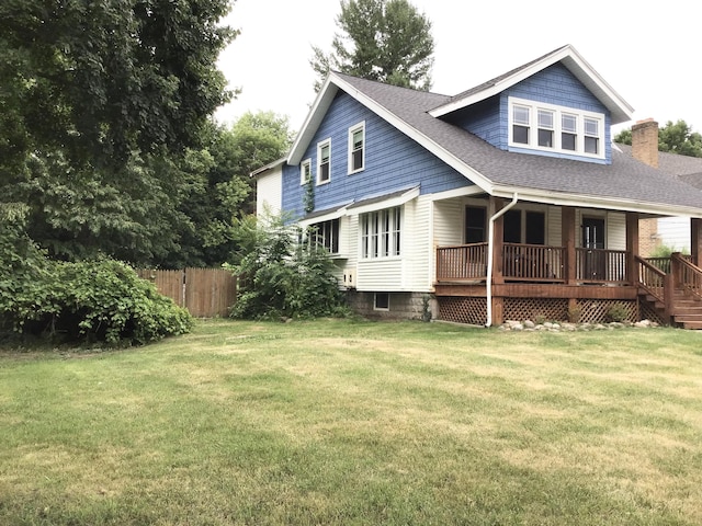 1116 Covell Ave NW, Grand Rapids, MI 49504 - back of house with covered porch, a shingled roof, and a chimney