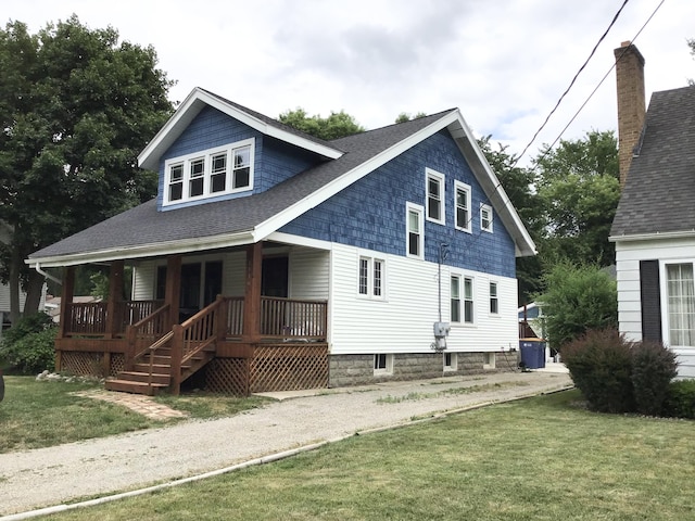 1116 Covell Ave NW, Grand Rapids, MI 49504 - rear view of property with covered porch, a lawn, and a shingled roof