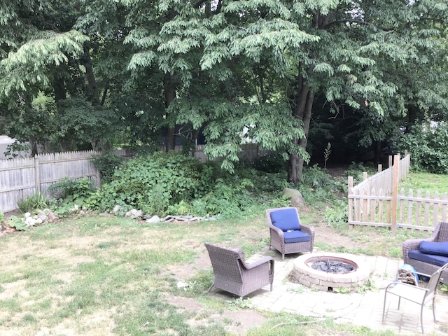 1116 Covell Ave NW, Grand Rapids, MI 49504 - view of yard featuring a fire pit and a patio