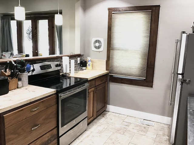 1116 Covell Ave NW, Grand Rapids, MI 49504 - kitchen featuring stainless steel range with electric cooktop, light countertops, and pendant lighting