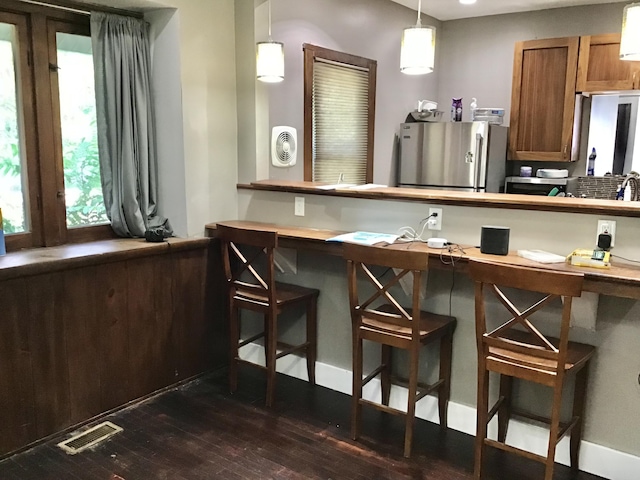 1116 Covell Ave NW, Grand Rapids, MI 49504 - bar with appliances with stainless steel finishes, dark wood-type flooring, and pendant lighting