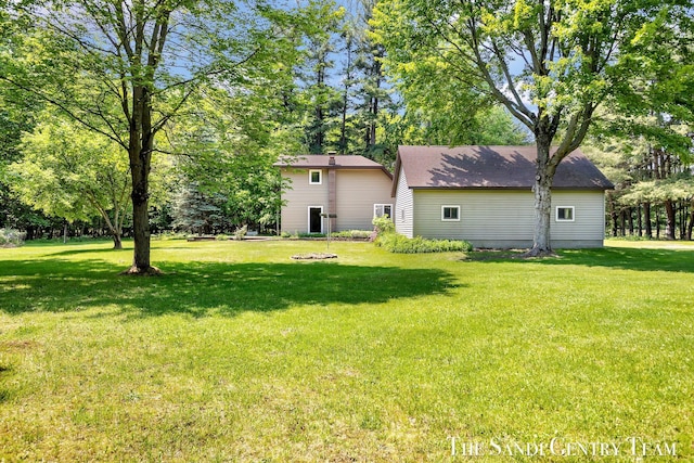 7120 Quarterline Rd, Spring Lake, MI 49456 - view of green lawn with view of wooded area
