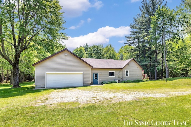 7120 Quarterline Rd, Spring Lake, MI 49456 - view of front of house with a front lawn and a garage