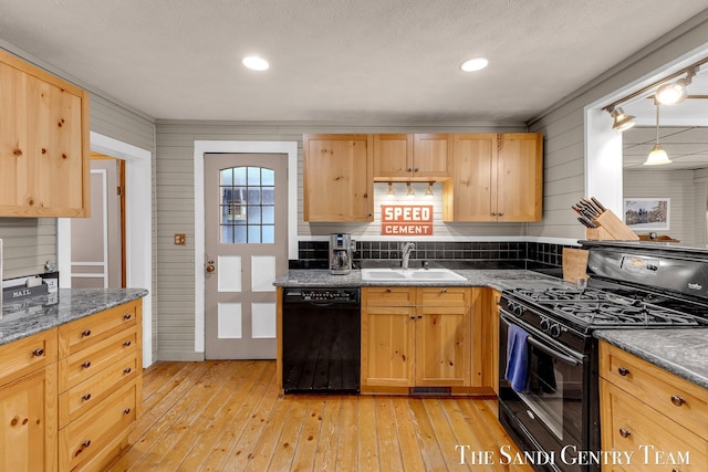 7120 Quarterline Rd, Spring Lake, MI 49456 - kitchen with black appliances, a sink, light brown cabinetry, and light wood-style flooring