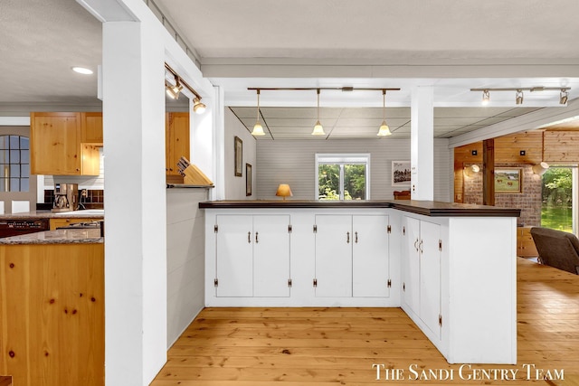 7120 Quarterline Rd, Spring Lake, MI 49456 - kitchen with dark countertops, light wood-style floors, white cabinetry, decorative light fixtures, and recessed lighting