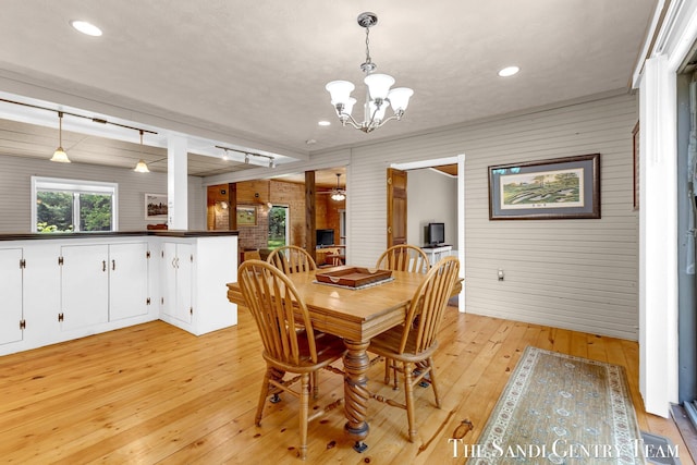 7120 Quarterline Rd, Spring Lake, MI 49456 - dining space with wood walls, light wood finished floors, a chandelier, recessed lighting, and ceiling fan