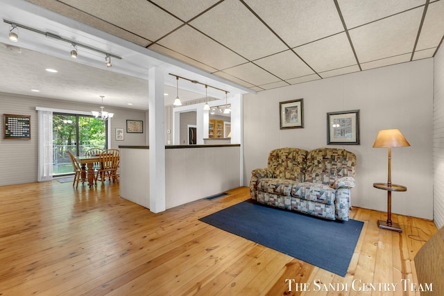 7120 Quarterline Rd, Spring Lake, MI 49456 - living area featuring wood-type flooring, a chandelier, and rail lighting