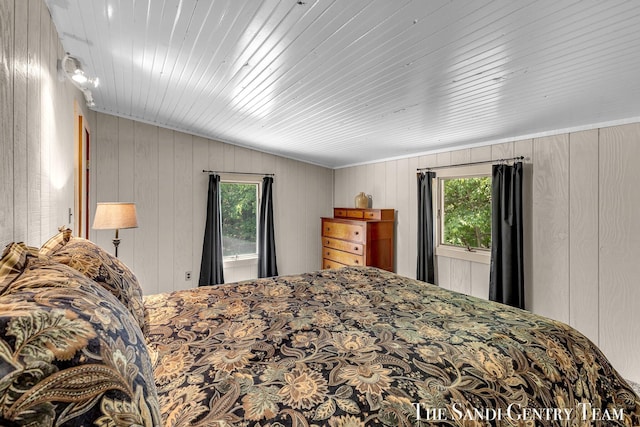 7120 Quarterline Rd, Spring Lake, MI 49456 - bedroom with multiple windows and wood walls
