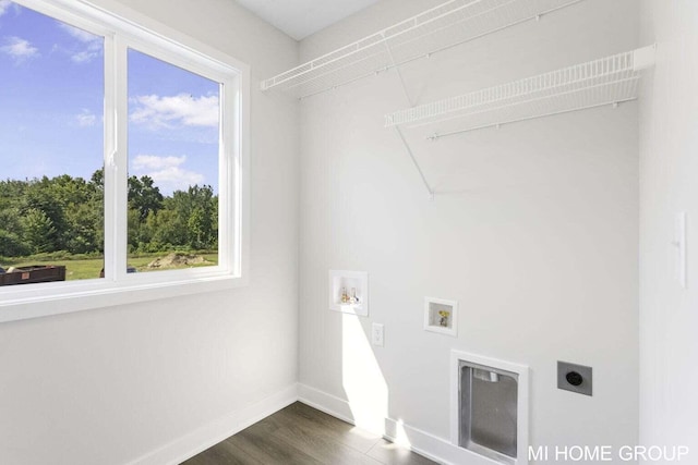 13654 Signature Dr, Holland, MI 49424 - washroom featuring hookup for an electric dryer, washer hookup, dark wood-style flooring, and baseboards