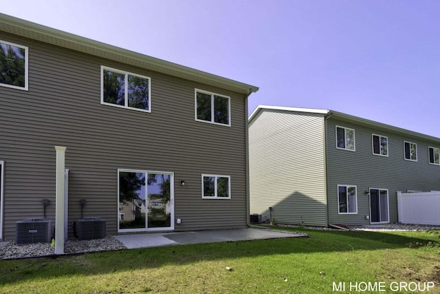 13654 Signature Dr, Holland, MI 49424 - back of house with cooling unit, a patio, and a lawn