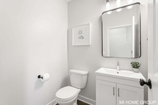13654 Signature Dr, Holland, MI 49424 - bathroom with toilet, vanity, and baseboards