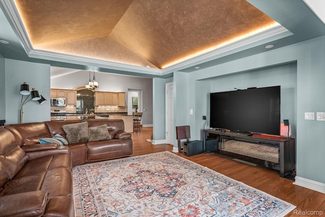900 Indianwood Rd, Lake Orion, MI 48362 - living area featuring a tray ceiling, a chandelier, baseboards, dark wood-style floors, and lofted ceiling