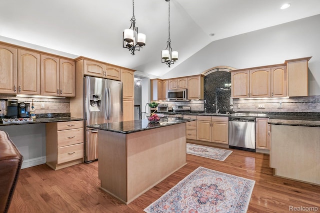 900 Indianwood Rd, Lake Orion, MI 48362 - kitchen featuring appliances with stainless steel finishes, light brown cabinets, vaulted ceiling, tasteful backsplash, and a center island