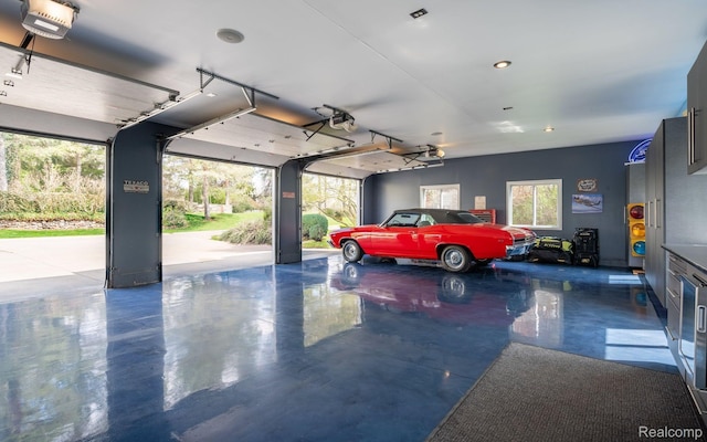 900 Indianwood Rd, Lake Orion, MI 48362 - garage featuring a garage door opener