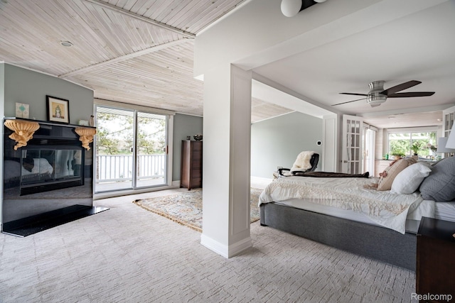 900 Indianwood Rd, Lake Orion, MI 48362 - carpeted bedroom with access to exterior, multiple windows, a glass covered fireplace, and a ceiling fan