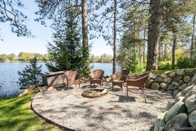 900 Indianwood Rd, Lake Orion, MI 48362 - view of patio with a fire pit and a water view