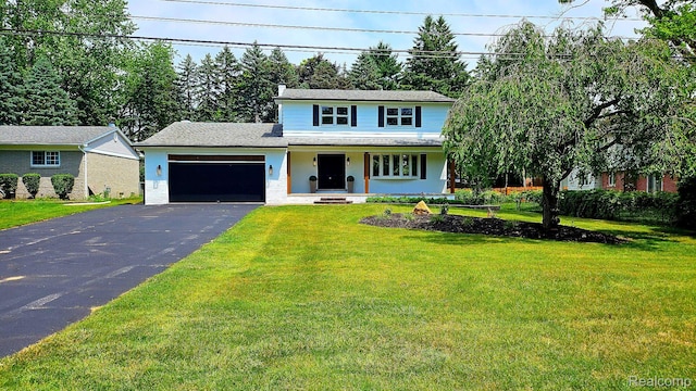 54232 Mound Rd, Shelby Twp, MI 48316 - view of front of house with driveway, a garage, covered porch, and a front lawn