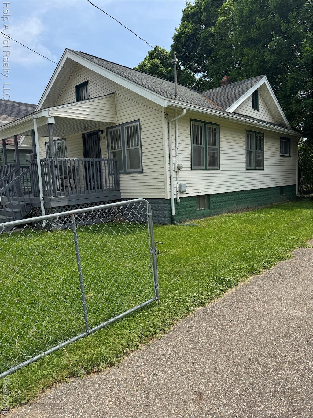 234 Mary St, Flint, MI 48503 - view of front of house featuring a porch, roof with shingles, and a chimney