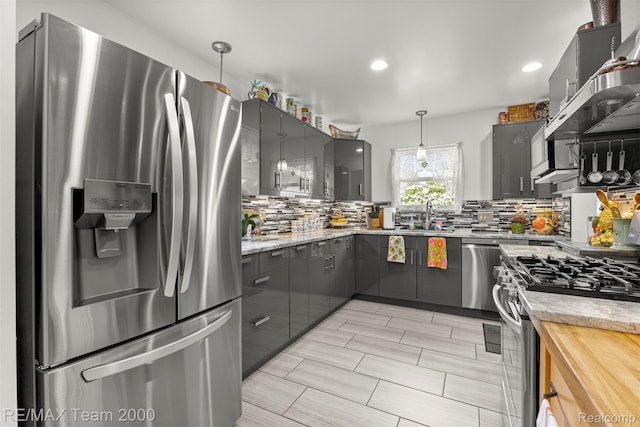 18155 Audette St, Dearborn, MI 48124 - kitchen with appliances with stainless steel finishes, gray cabinets, tasteful backsplash, wall chimney exhaust hood, and a sink