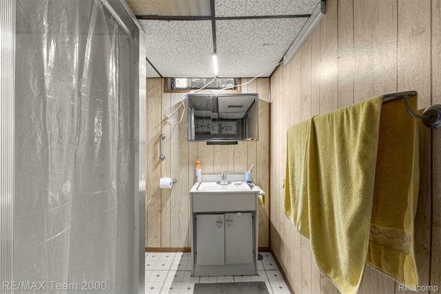 18155 Audette St, Dearborn, MI 48124 - bathroom featuring wooden walls, vanity, tile patterned floors, and a shower with shower curtain