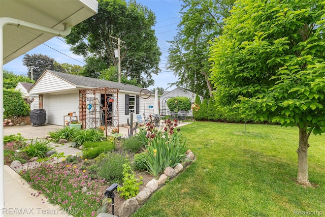 18155 Audette St, Dearborn, MI 48124 - view of grassy yard featuring an outdoor structure and a detached garage