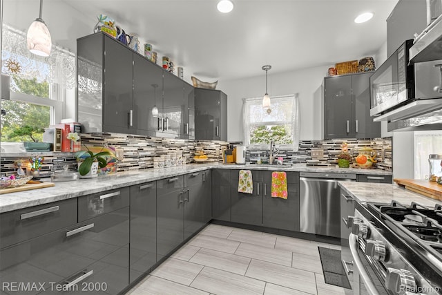 18155 Audette St, Dearborn, MI 48124 - kitchen with stainless steel appliances, decorative backsplash, a sink, gray cabinetry, and recessed lighting