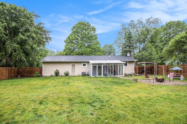 46915 Anthony St, Paw Paw, MI 49079 - rear view of house with an outdoor fire pit, a sunroom, and a chimney