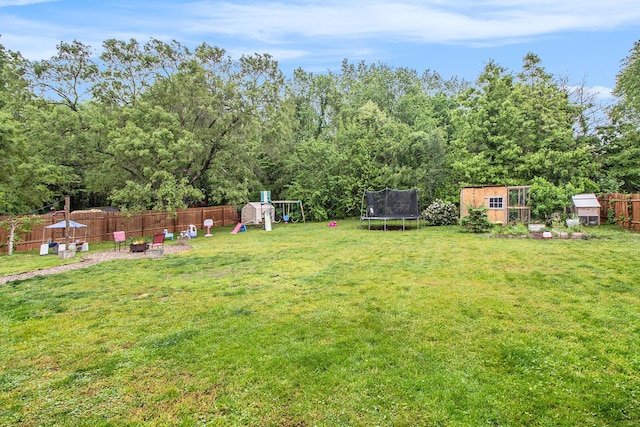 46915 Anthony St, Paw Paw, MI 49079 - view of yard featuring a trampoline, a playground, and a fire pit