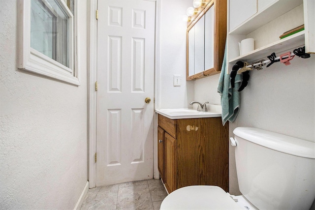 46915 Anthony St, Paw Paw, MI 49079 - bathroom featuring toilet, vanity, baseboards, and tile patterned floors