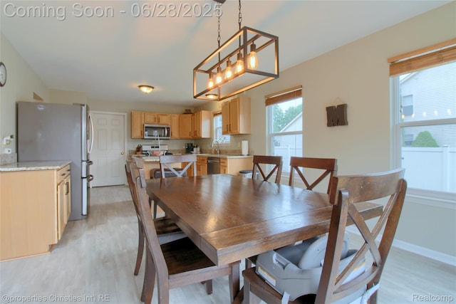 18594 Lawrence Ln, New Boston, MI 48164 - dining area with light wood-type flooring and a chandelier