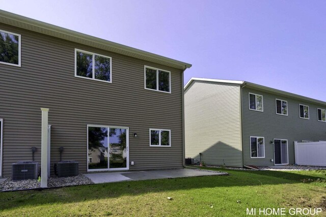 13656 Signature Dr, Holland, MI 49424 - back of house with cooling unit, a patio, and a lawn