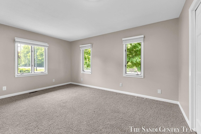 6372 Lake Harbor Rd, Norton Shores, MI 49441 - carpeted spare room featuring baseboards