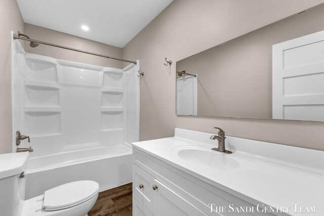 6372 Lake Harbor Rd, Norton Shores, MI 49441 - full bathroom featuring toilet, wood finished floors, vanity, and shower / bathtub combination