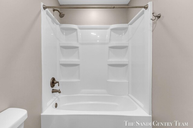 6372 Lake Harbor Rd, Norton Shores, MI 49441 - bathroom featuring toilet and bathing tub / shower combination