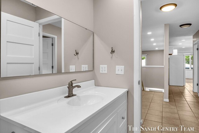 6372 Lake Harbor Rd, Norton Shores, MI 49441 - bathroom with tile patterned floors, vanity, baseboards, and recessed lighting