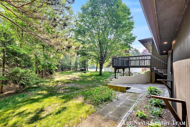 6372 Lake Harbor Rd, Norton Shores, MI 49441 - view of green lawn featuring stairs and a deck