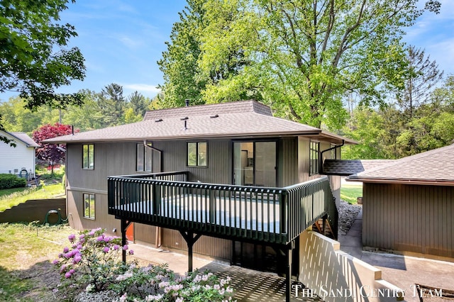 6372 Lake Harbor Rd, Norton Shores, MI 49441 - back of house featuring a shingled roof and a wooden deck