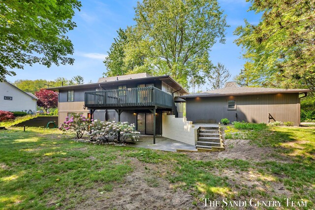 6372 Lake Harbor Rd, Norton Shores, MI 49441 - back of house with a patio area, a lawn, a chimney, and a deck