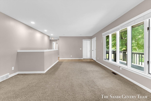 6372 Lake Harbor Rd, Norton Shores, MI 49441 - carpeted empty room featuring baseboards and recessed lighting