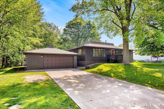 6372 Lake Harbor Rd, Norton Shores, MI 49441 - view of front of home with a garage, a front yard, and a chimney