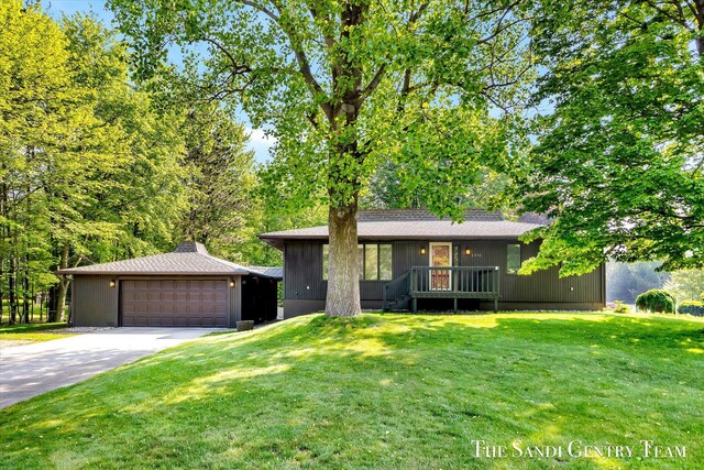 6372 Lake Harbor Rd, Norton Shores, MI 49441 - view of front of house featuring a front yard, a garage, and concrete driveway